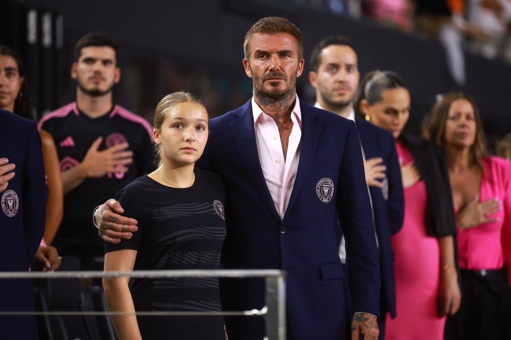 David Beckham looks proud as he wraps his arm around his daughter Harper