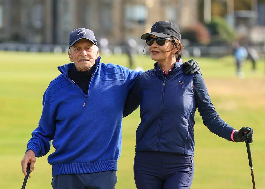 michael douglas catherine zeta-jones hugging on golf course