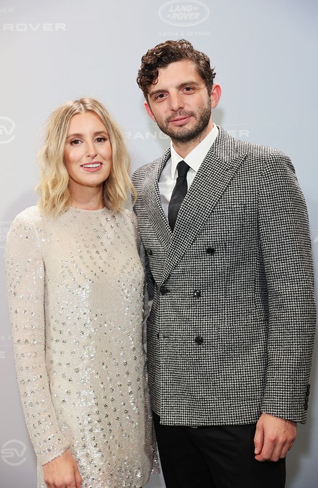 Laura Carmichael wearing a white beaded dress and Michael Fox wearing a check blazer in black and white