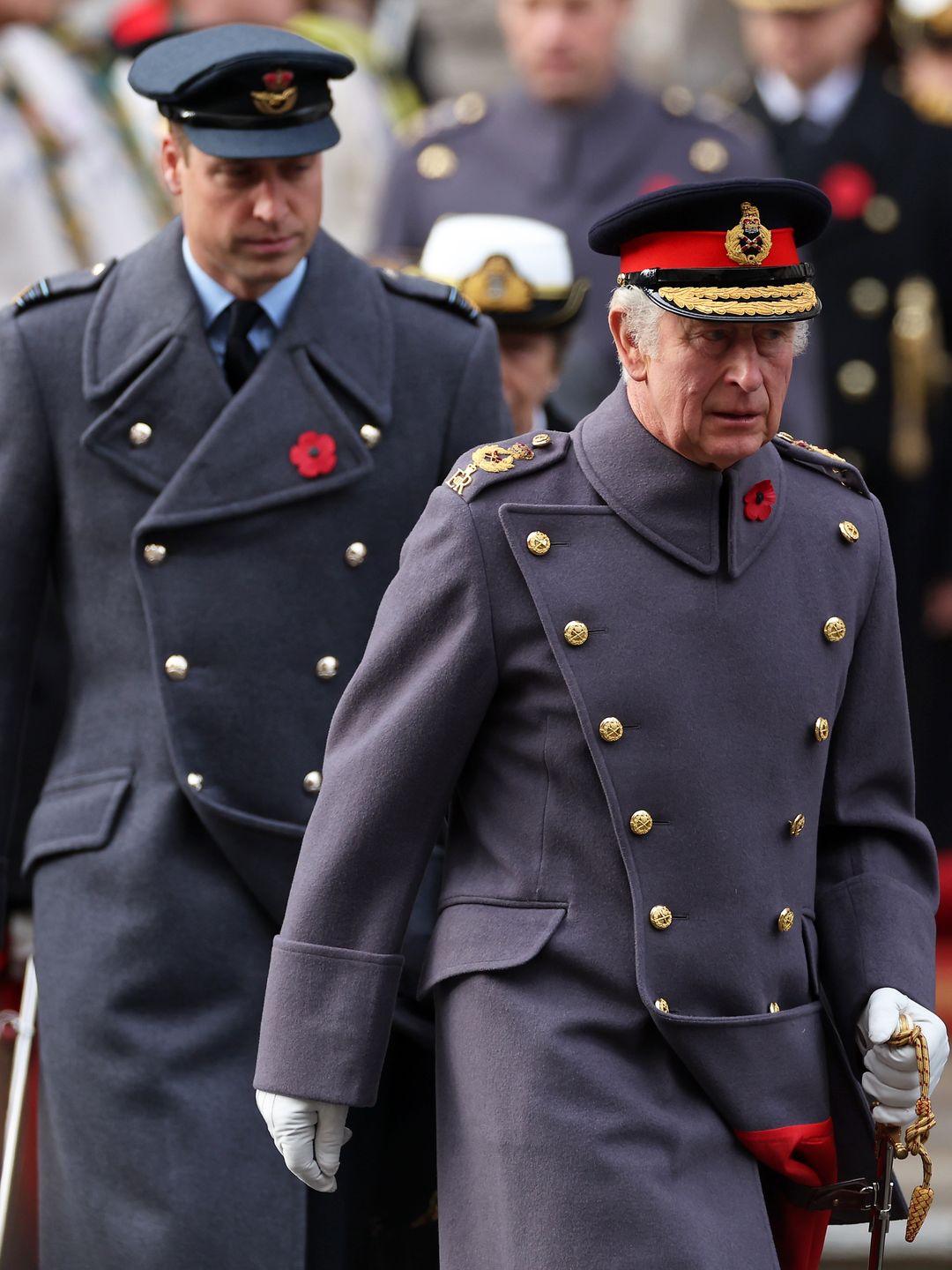 King Charles walking with Prince William and Prince Edward behind him