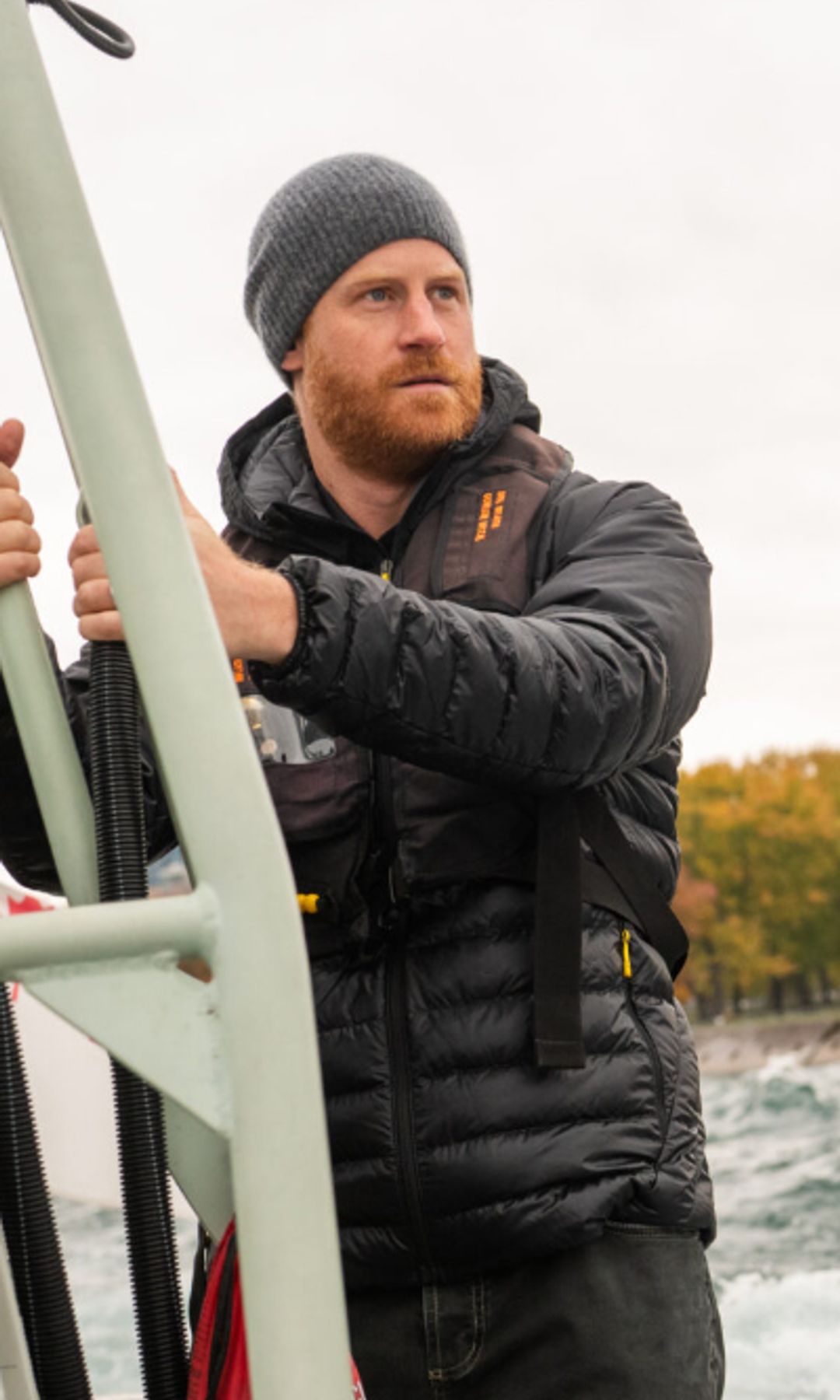 prince Harry on the side of a boat