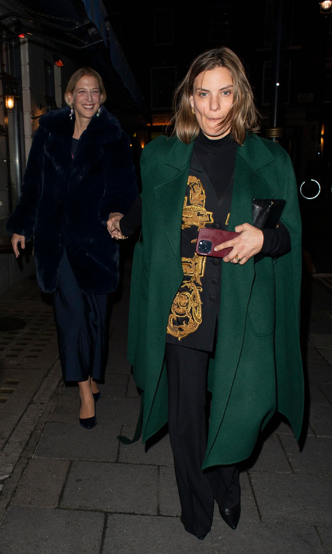Lady Gabriella Windsor holding hands with a female friend