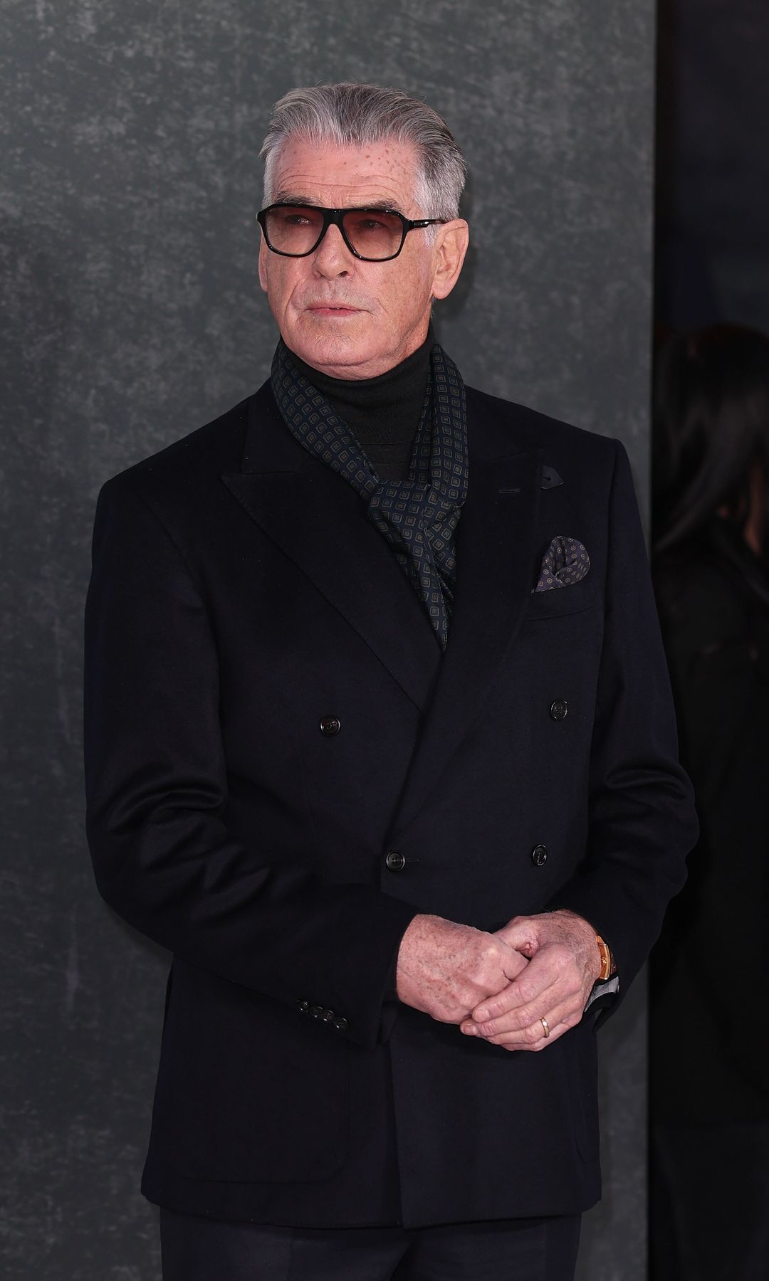 Pierce Brosnan in a black coat
