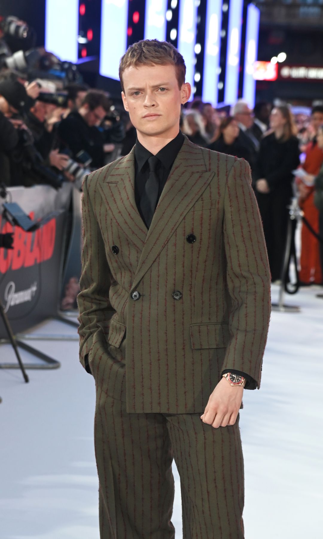 Anson Boon in a green suit