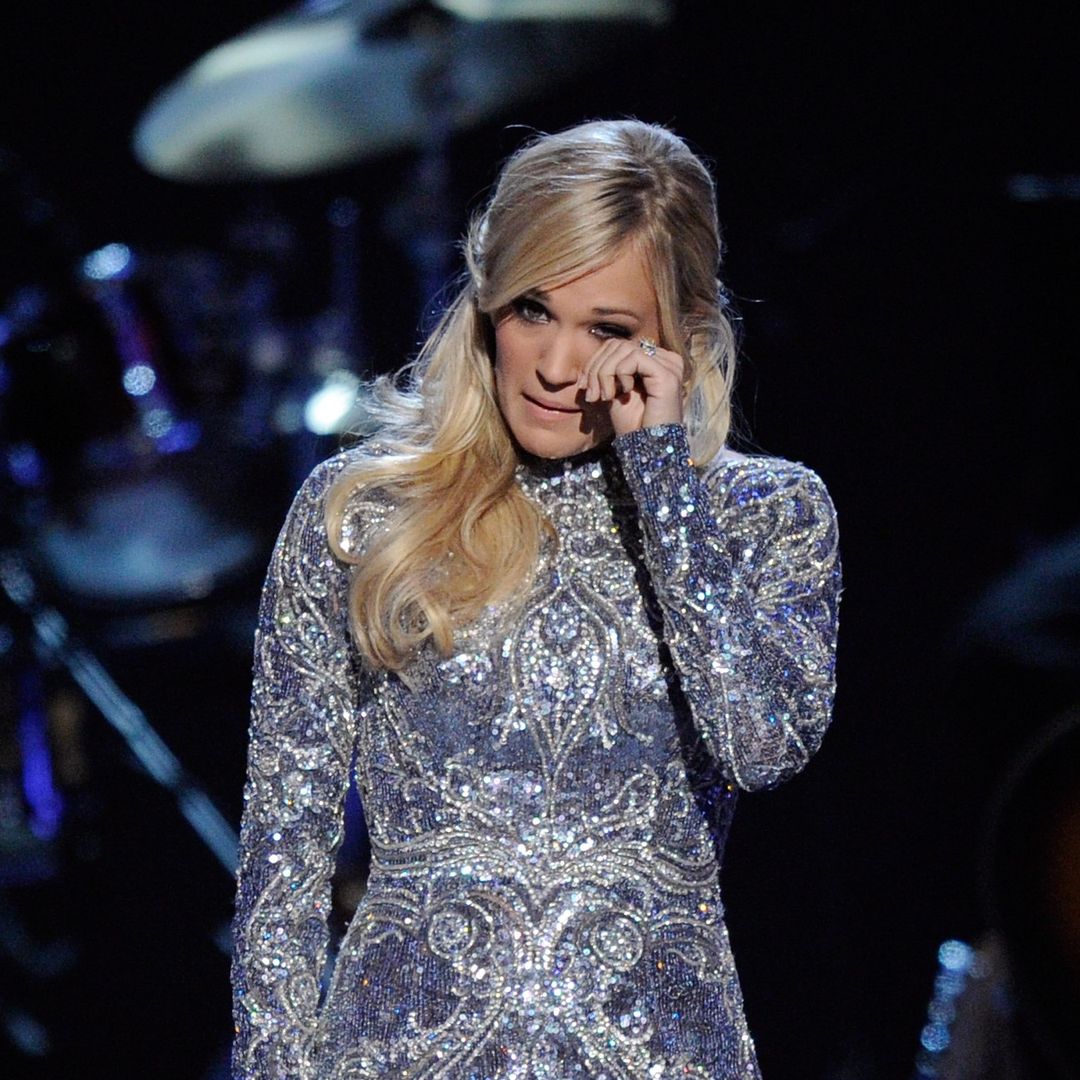 Carrie Underwood wipes away tears as she admits she's 'not ok'
