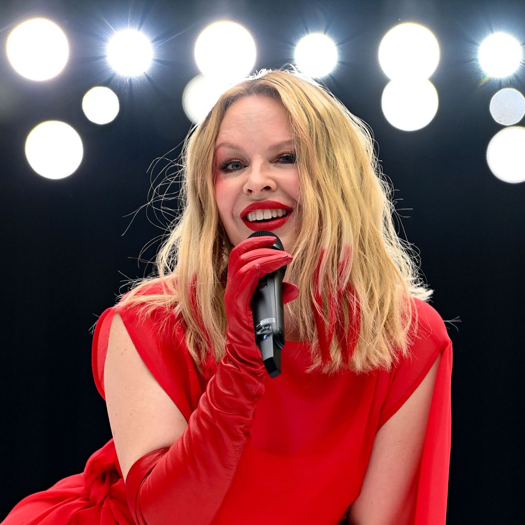Kylie Minogue dazzles in glittering feathered mini dress