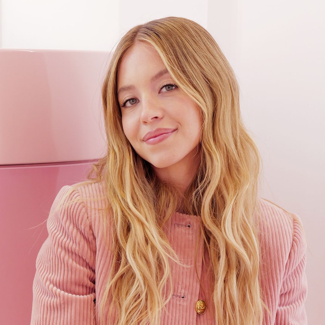 Sydney Sweeney's crop top, flared jeans and velvet jacket combo is SS25-approved