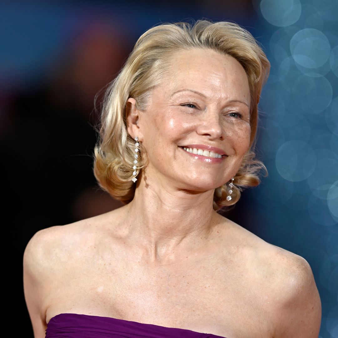 Pamela Anderson's romantic mini dress and sheer tights are so on-trend