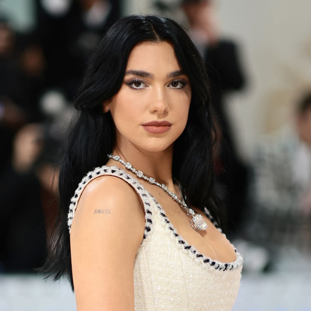 Dua Lipa revives pinstripes in plunging bra and lace-up skirt