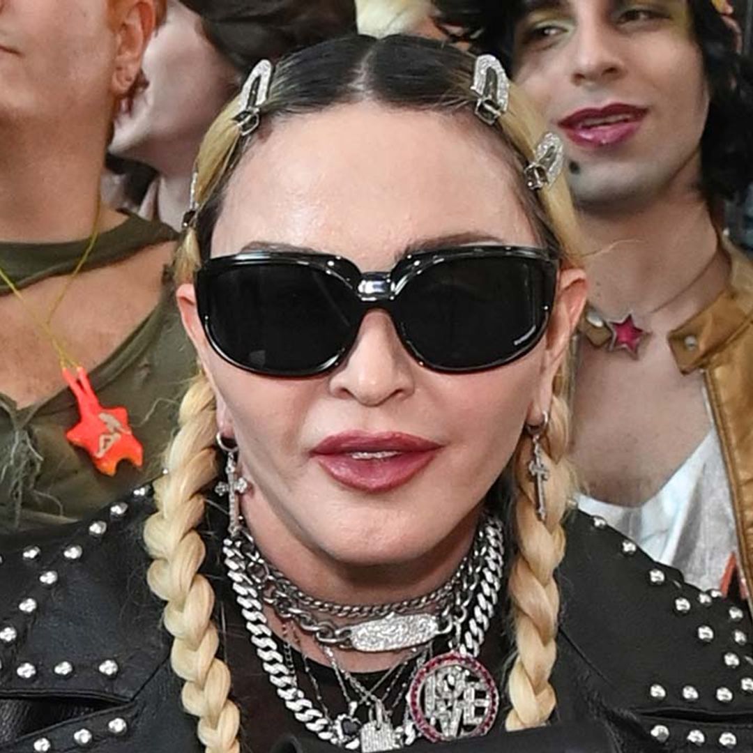Madonna goes hell for leather in lace corset and cropped sweater