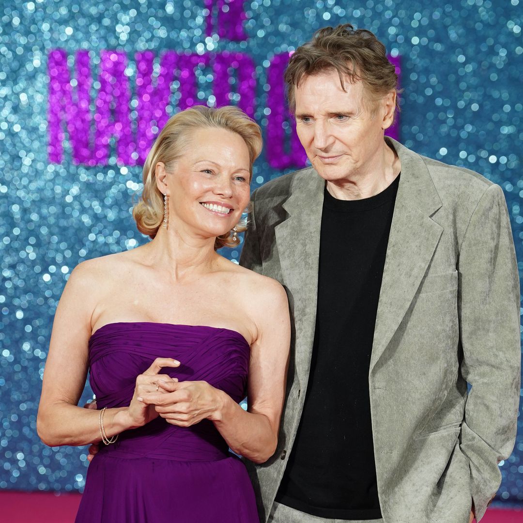 Pamela Anderson and Liam Neeson can't keep their hands off each other in loved up red carpet display