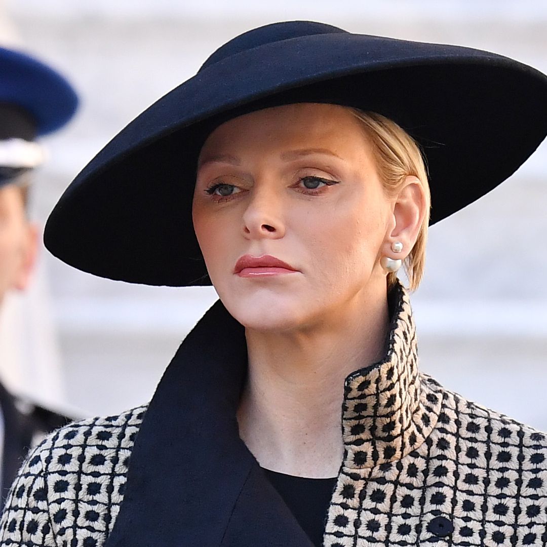 Princess Charlene looks sombre in knee-grazing funeral dress and lace veil
