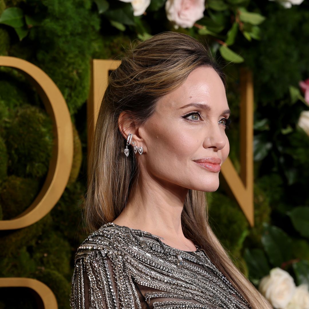 Angelina Jolie strikes a pose with daughter Zahara as her Golden Globes date